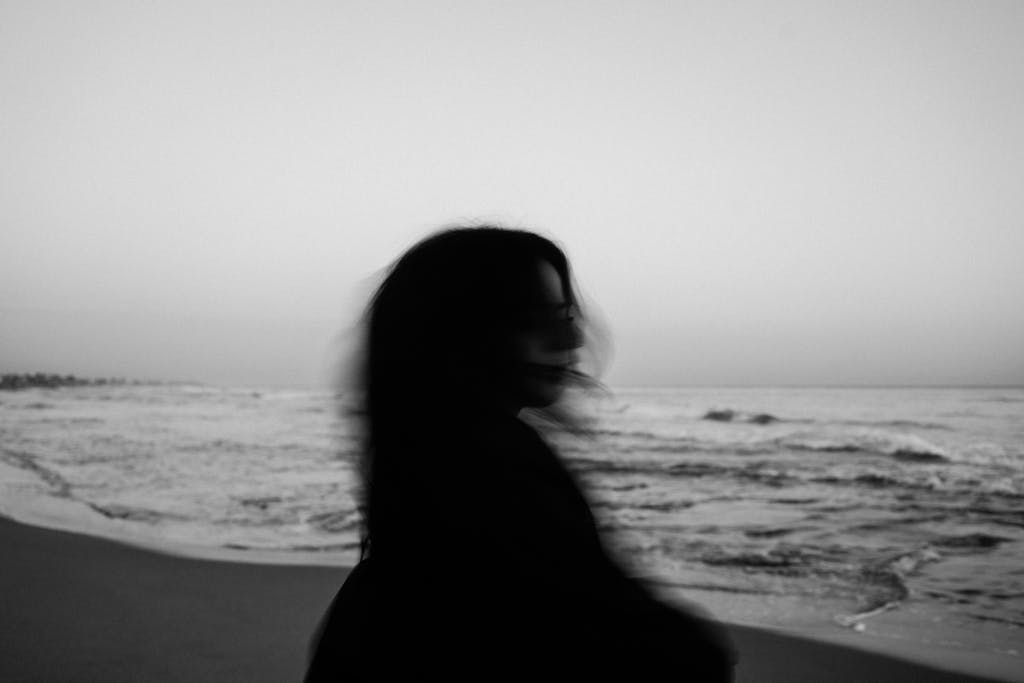 Anonymous woman standing on beach