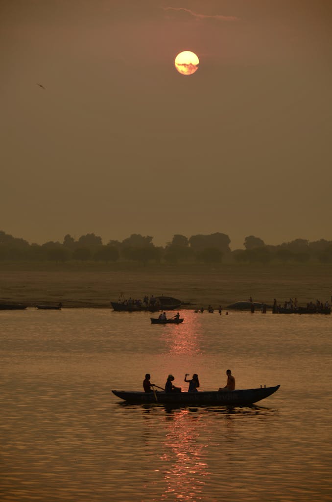 People Riding a Boat on Lake