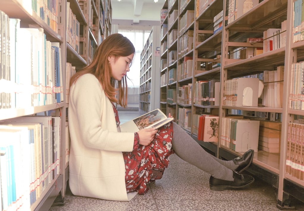 Photo of a Woman Reading Book